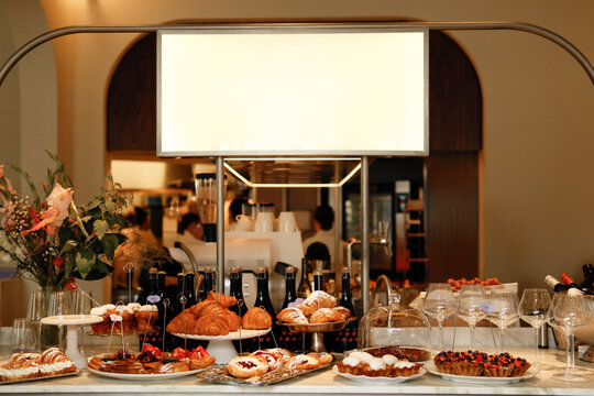 Elegant Bakery Counter with Croissants, Pastries and Wine Glasses