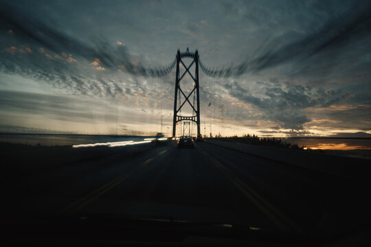 Sunset view with bridge and clouds on the horizon during evening