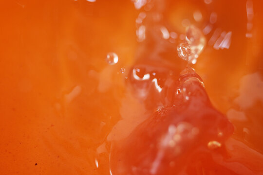Close up of apple cider vinegar liquid. It made by fermenting apples can help with weight loss efforts, lower sugar cravings and reduce bloating