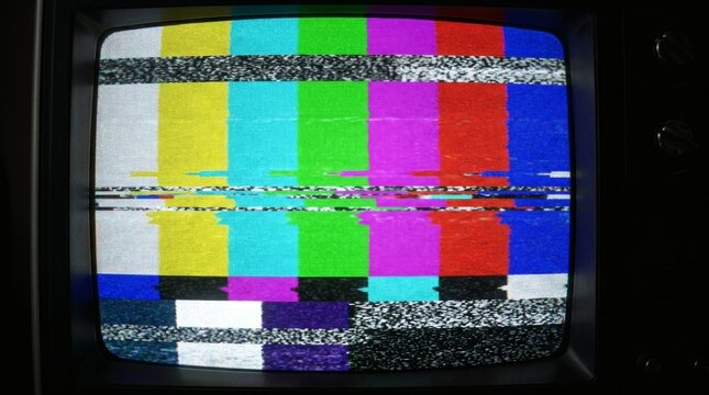 Vintage television screen with colorful static and test pattern on display clearly