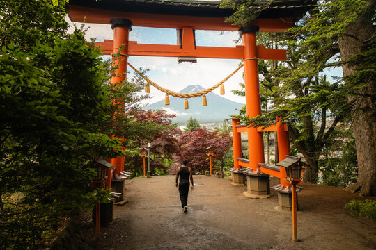 Walking under red torii gate at Arakura Fuji Sengen Shrine