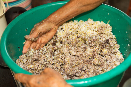 Anonymous person Working with corn and cacao Dough