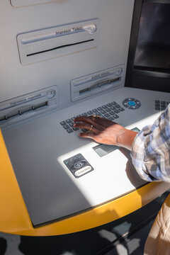 Anonymous woman using ATM 