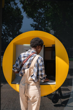 Woman using ATM
