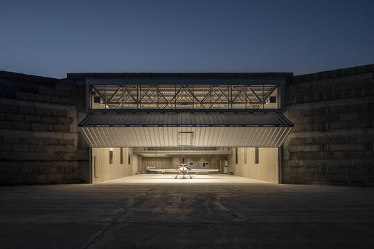 Illuminated Aircraft Hangar at Dusk