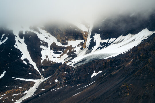 Svalbard mountains covered in snow and fog, arctic landscape