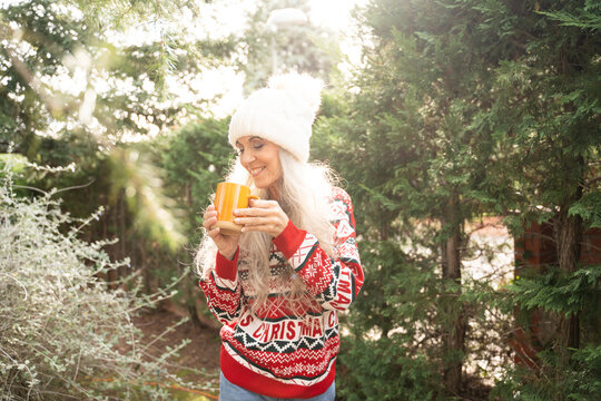 Smiling Woman with tea in Winter During Christmas Time