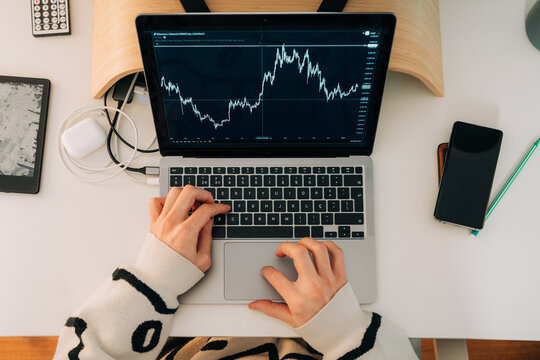 Laptop Screen Showing Financial Chart on Desk