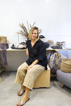 A woman is giving a master class on making bags.
