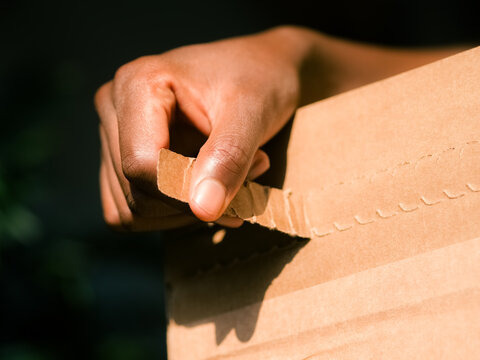 Woman unsealing box 