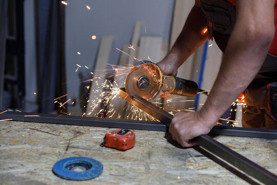 Man cuts steel square hollow section