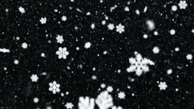 Falling snow flakes during winter in a dark environment showing natural weather effects and patterns