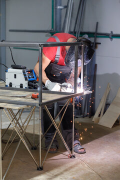 Welder welding steel construction