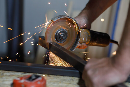 Man cuts steel square hollow section