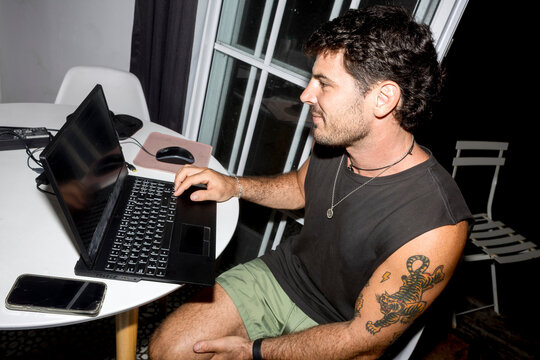 ugc Man using laptop at home with direct flash