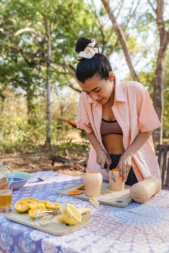 Outdoor kitchen preparation peeling butternut squash for cooking