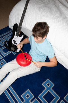 Teenager with drum bedroom dusk