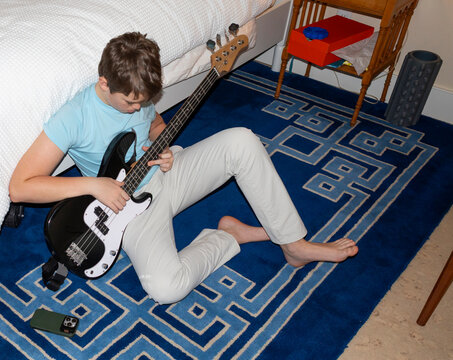 Teenager Lifestyle boy playing  Bass guitar 
