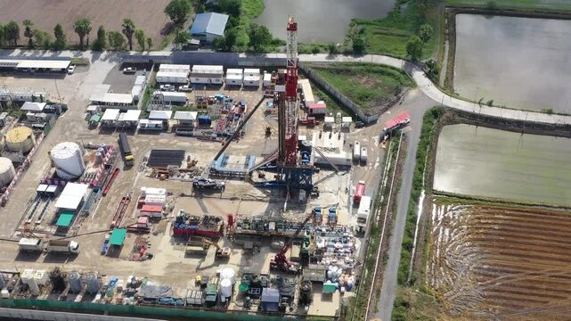Aerial View of Land Drilling Rig and Oilfield Facility in Rice Fields