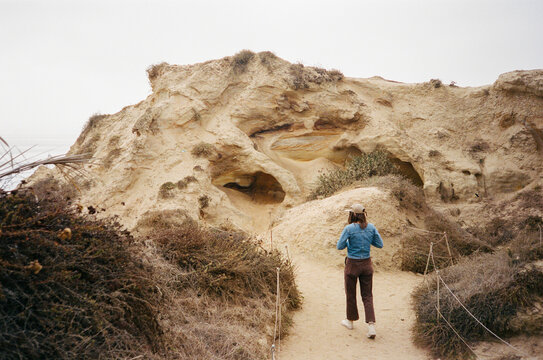 tourist exploring coastal scenic beach torrey pines, san diego
