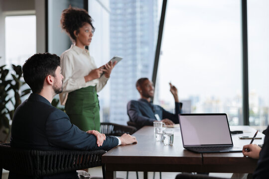 Business meeting in a modern office with city view.