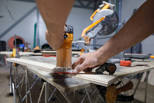 Carpenter chamfers a plank