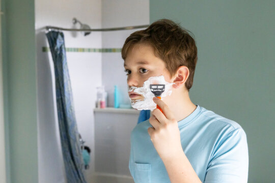 Portrait Teenager Lifestyle boy shaving first time razor