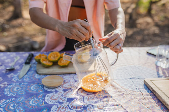 Preparing fresh beverage by whisking citrus juice in pitcher