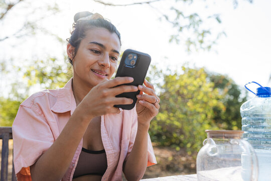 Adult individual using smartphone outdoors connecting online