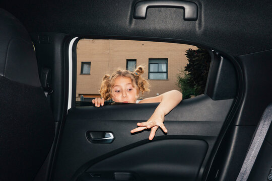 Girl framed through car window looking inside