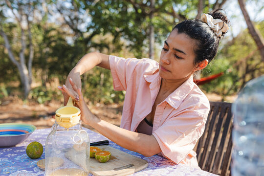 Squeezing fresh citrus juice outdoors for healthy refreshment
