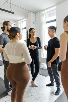 People listening and looking at asian man telling something to them
