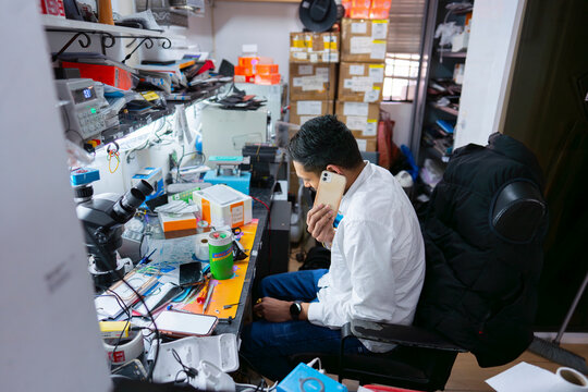 Technician working in electronics workshop