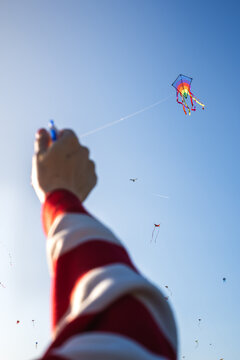 Anonymous hand flying kite 