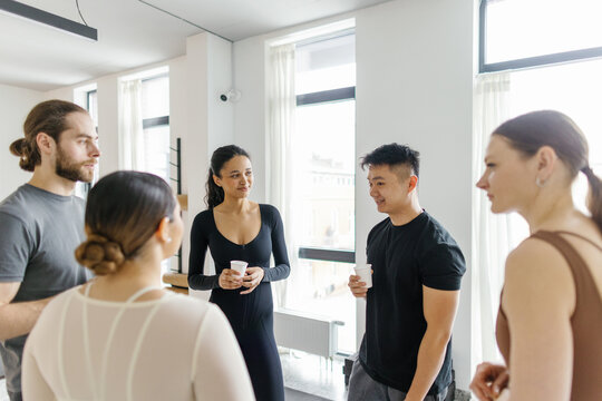 People talking, drinking and looking at each other after training