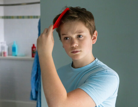 Teen boy Portrait Lifestyle comb Hair in Mirror bathroom 