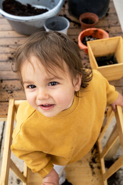 Baby Portrait Looking At Camera During Gardening Activity