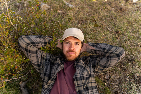 Man Lying on Grass With Hands Behind Head 