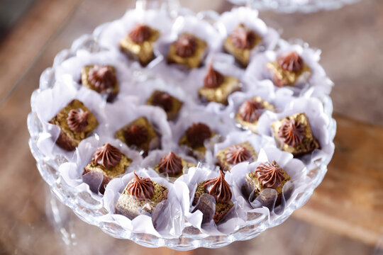 Gourmet Chocolate Camafeu Sweets with Gold Dust and Ganache on Luxury Crystal Tray