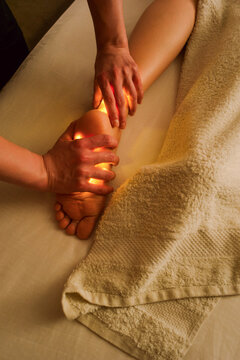 Person Receiving Massage on Ankle and Foot in a Treatment Room