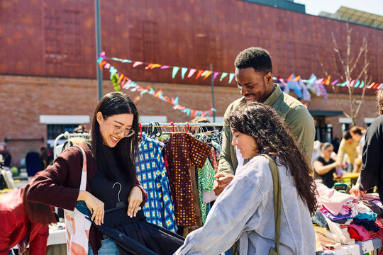 Friends Shopping Together at Clothes Street Fair