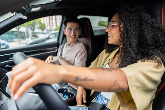 Happy young couple traveling together in a car