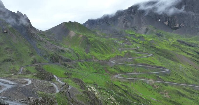 Aerial view of beautiful high altitude grassland mountain and winding road  landscape