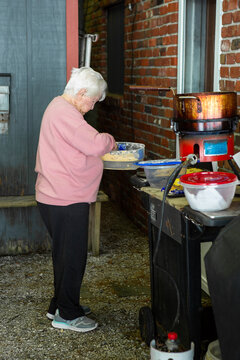 Old Woman Frying Fish at the Lake