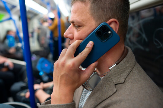 Man talking on smartphone in subway