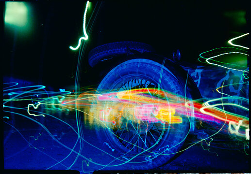 Long Exposure Light Trails Near a Car Tire at Night