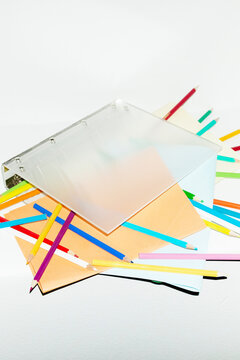 Contemporary office image of binder full of papers and pencils