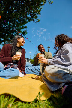 Diverse Group of Friends Relaxing Outdoors at Street Fair