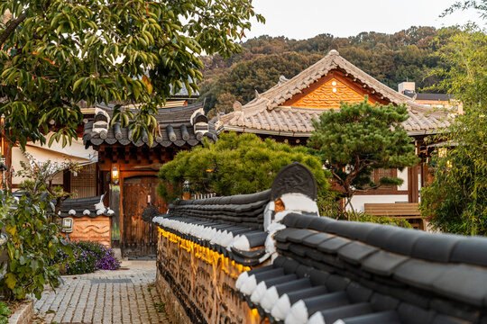 Curved tiled wall leading to traditional house in Jeonju