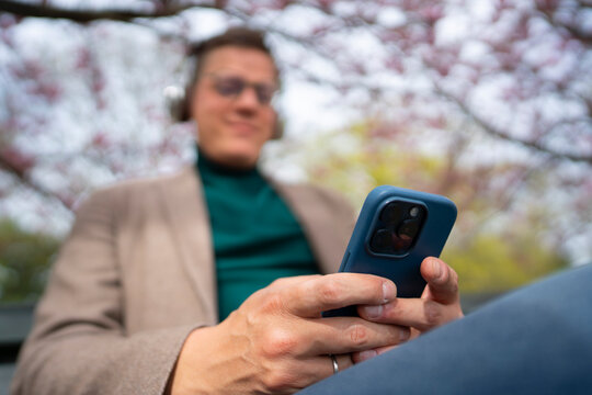 Close up of man using smartphone outdoors